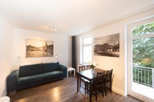 a living room with a couch and a table at L.E. Home in Leipzig