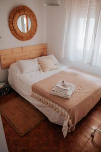 a bedroom with a bed with a mirror on the wall at Aquí Ahora San José in San José