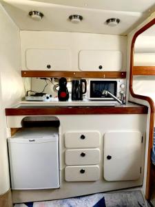 a kitchen in an rv with a sink at Cozy private two rooms yacht in Barcelona - boat in Port Forum in Barcelona