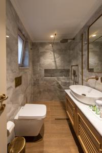 a bathroom with a toilet and a sink at Capolavoro Suites in Zakynthos Town