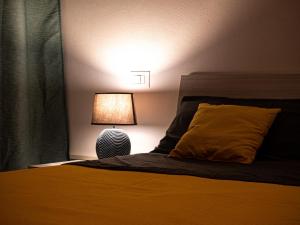 a bedroom with a bed with a lamp next to it at [Near Center] Design in Borgo Panigale in Bologna