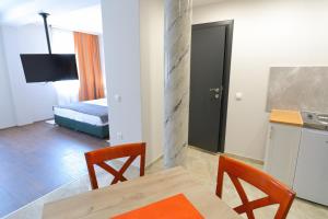 Cette chambre comprend une table, des chaises et un lit. dans l'établissement Fenix Apartments, à Sokobanja