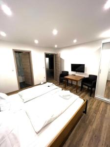 1 dormitorio con 1 cama grande, mesa y sillas en Hotel Zur Post, en Geest