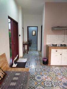 a room with a kitchen with a tile floor at Zen Résidence Laos #5 to #8 in Luang Prabang