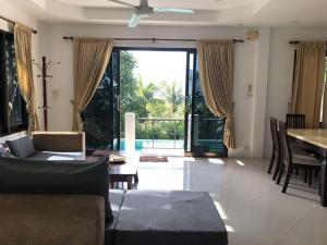 a living room with a couch and a table at Villa Seaview Garden in Ko Tao