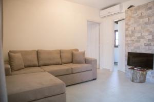 a living room with a couch and a fireplace at Ilenia Guesthouse in Zagora