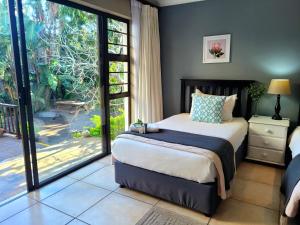 a bedroom with a bed and a large sliding glass door at Tropical Seaside Suite 8 in East London