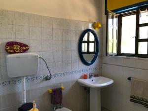 a bathroom with a sink and a mirror at Cosy apartment in a relaxing area close to Lecce in Frigole