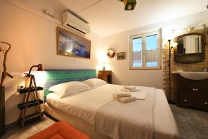 a bedroom with a bed and a sink and a mirror at ADMIRAL'S VILLA in Loutra