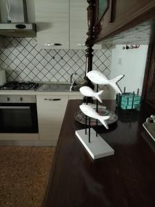 a kitchen with two white shelves on a counter at La casa di Lelè in Termoli