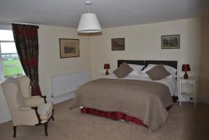 a bedroom with a bed and a chair at Church house 