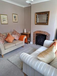 a living room with two couches and a fireplace at Character Beverley Town House in Beverley