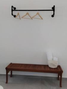 a wooden bench sitting in a room with towels at Bay-dream 1 in Adamas