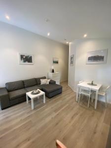 a living room with a couch and a table at Sjölanda in Sjuntorp