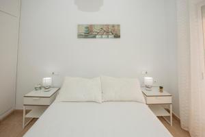 カンポアモールにあるCristina IVの白いベッドルーム(大型ベッド1台、ナイトスタンド2台付)
