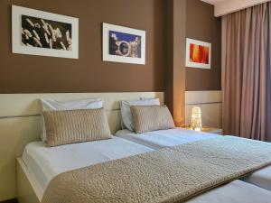 Llit o llits en una habitació de Hotel Argentum