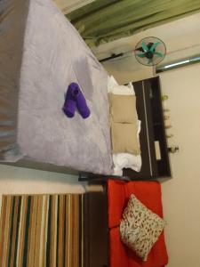 een tas met paarse schoenen aan de muur bij Studio for Rent near Ortigas Extension in Cainta