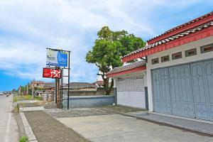 a building with a sign on the side of a street at OYO Life 91399 Homestay Trendy Syariah in Cilacap