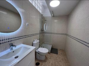 a white bathroom with a sink and a toilet at Las Palmeras in Benalmádena +41 photos