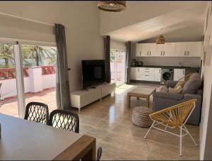a living room with a couch and a table at Las Palmeras in Benalmádena