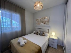 a small bedroom with a bed and a window at Las Palmeras in Benalmádena
