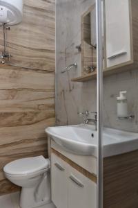 a bathroom with a white sink and a toilet at 4-teen in Jagodina