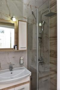 a bathroom with a glass shower and a sink at 4-teen in Jagodina