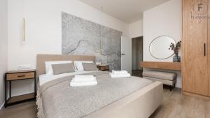 sypialnia z dużym łóżkiem i lustrem w obiekcie Flatbook - Yacht Harbor Apartments Sol Marina w mieście Wiślinka