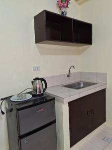 a kitchen with a sink and a counter top at Aliyahs’s Place: Staycation in Valley Golf Cainta in Cainta