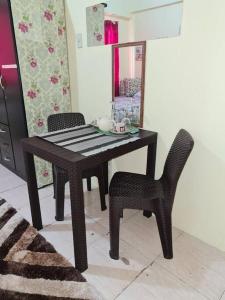 a black table and a chair and a mirror at Aliyahs’s Place: Staycation in Valley Golf Cainta in Cainta