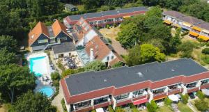 an aerial view of a house with a train at Hotel De Torenhoeve in Burgh Haamstede