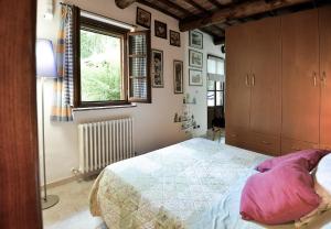 a bedroom with a large bed and a window at Loft in Antico Mulino in Isola d'Arbia