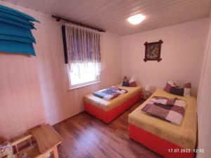 a room with two beds and a window at Holiday home Fuhlendorf 2 in Fuhlendorf