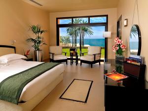 a bedroom with a bed and a view of the ocean at The Cove Rotana Resort - Ras Al Khaimah in Ras al Khaimah