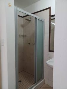 a glass shower in a bathroom with a sink at The cozy 1 bedroom apartment in Midrand