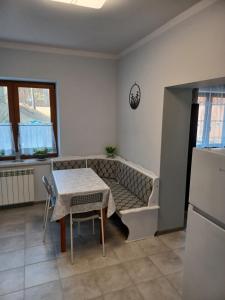 a living room with a table and a couch at Agroturystyka Leśna Ostoja Borek in Golczowice