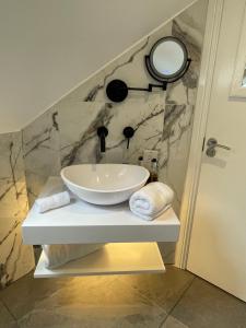 a bathroom with a sink and a mirror at Beach Lodge in Bournemouth