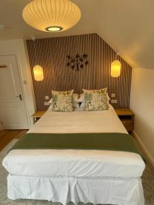 a bedroom with a large white bed with two lamps at Beach Lodge in Bournemouth