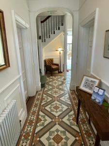a hallway with a tile floor and a table at Beach Lodge in Bournemouth