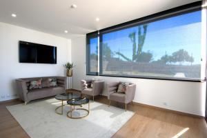 a living room with a large window and a couch at Monte Bela Vista in Macedo de Cavaleiros