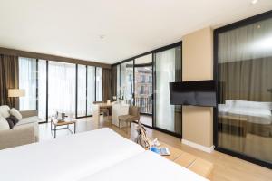 a bedroom with a large bed and a living room at Guitart Grand Passage in Barcelona