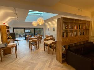 a dining room with tables and chairs and a library at Beach Lodge in Bournemouth