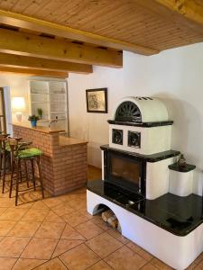 a kitchen with a stove and a bar at Apartmán u potoka in Bujanov