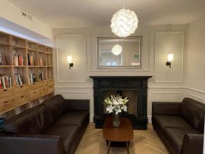 a living room with two couches and a fireplace at Beach Lodge in Bournemouth