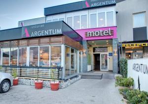 Hotel Argentum في موستار: يوجد متجر أمام السوق مع نباتات الفخار في الأمام