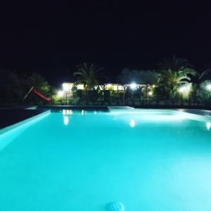 a swimming pool at night with blue lights at Agriturismo Isidoro in Fertilia