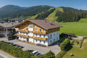 an aerial view of a large house in the mountains at Aparthotel Stadler in Flachau