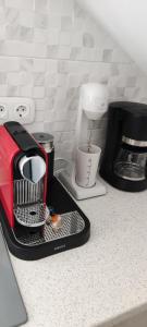 a kitchen counter with a toaster and a coffee maker at Ninemia Apartment in Artemonas