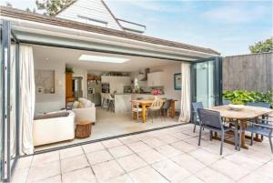 a living room and dining room with a patio extension at Beautiful 4 Double Bedroom House in Poole with Hot tub, near Sandbanks in Poole