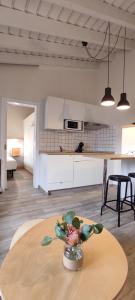 a kitchen with a table with a vase on a table at La Finca III in Breña Baja